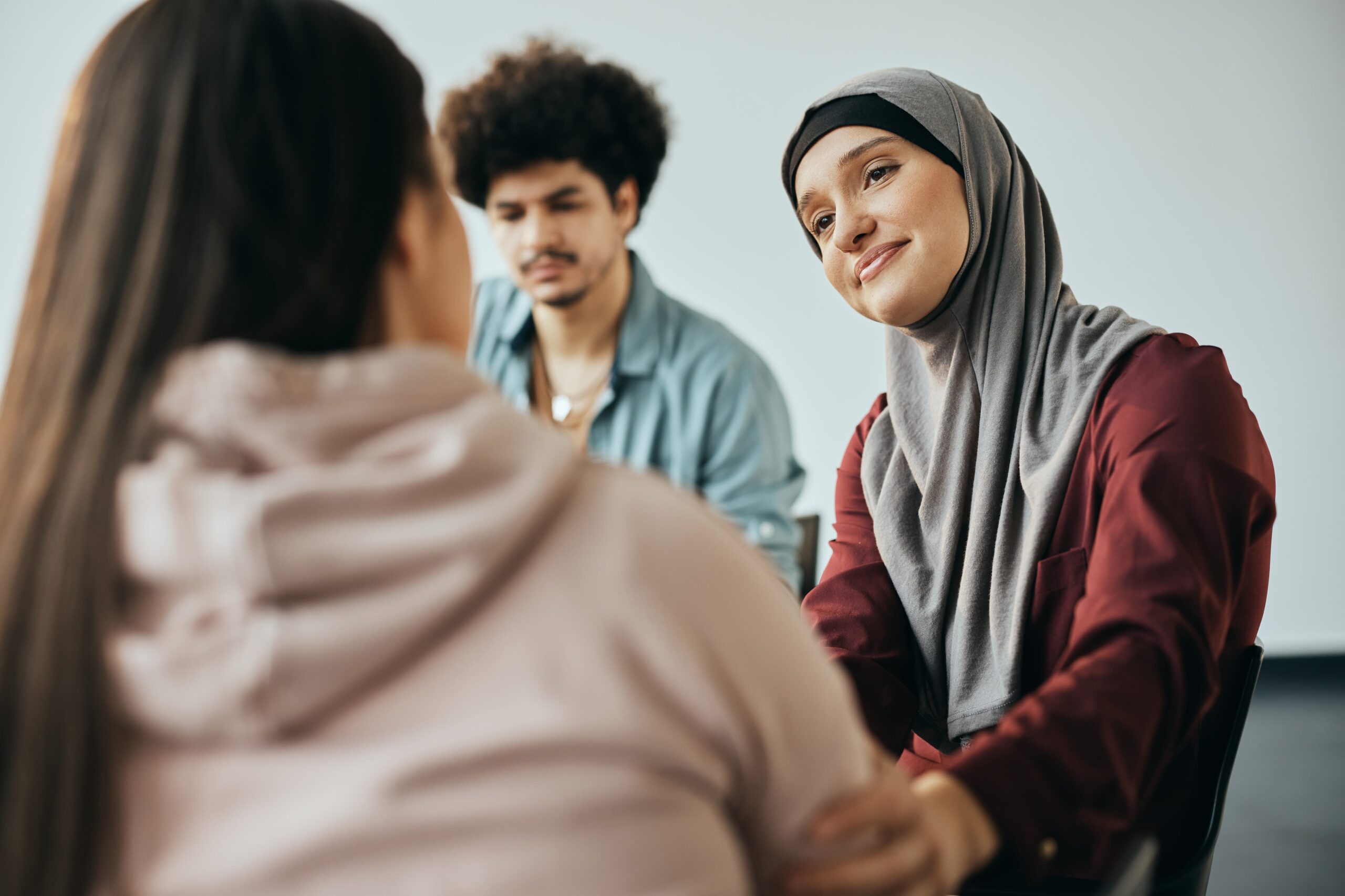 recovery support group sitting in a circle sharing stories