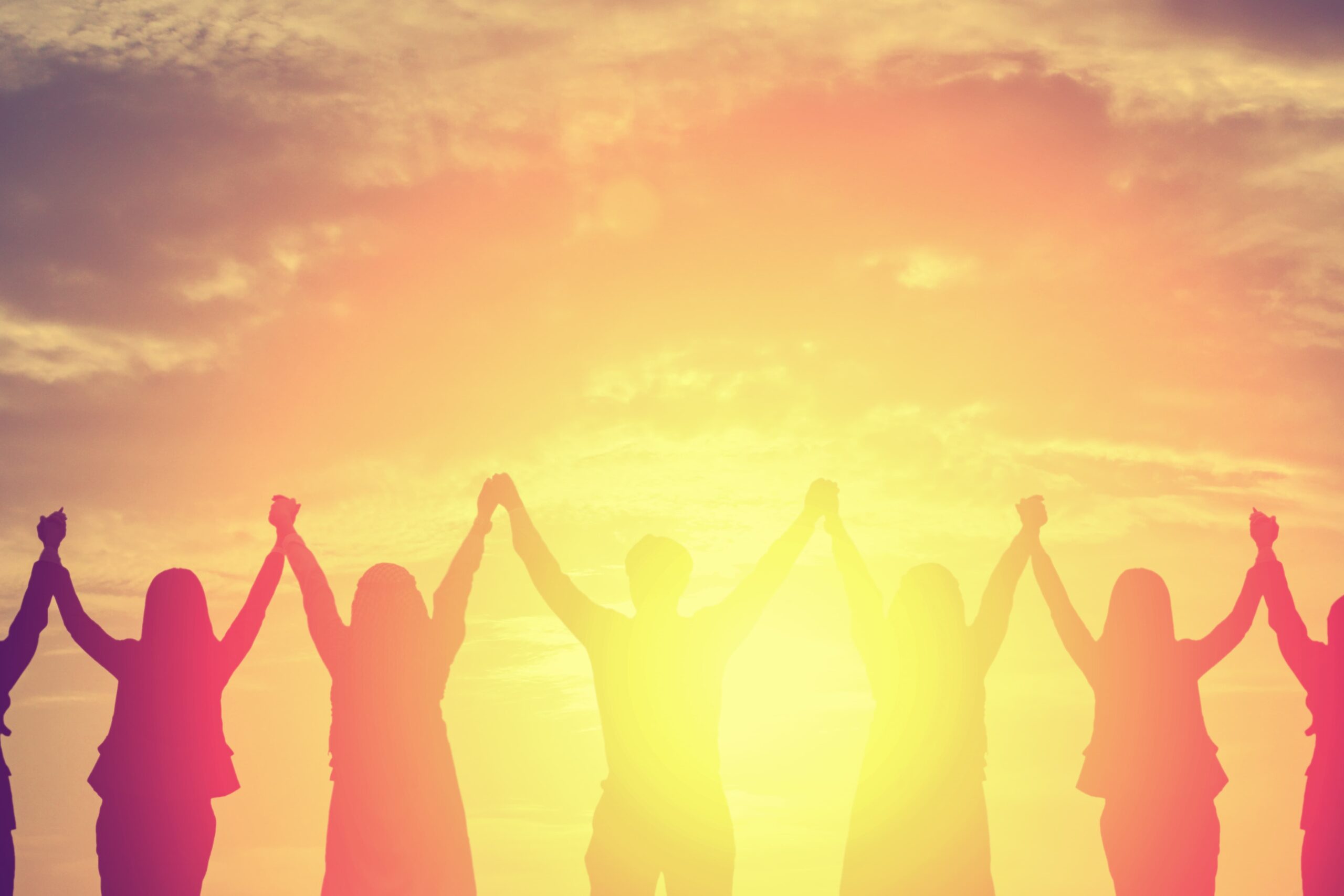 Silhouette of happy business team making high hands in sunset sky background for business teamwork concept