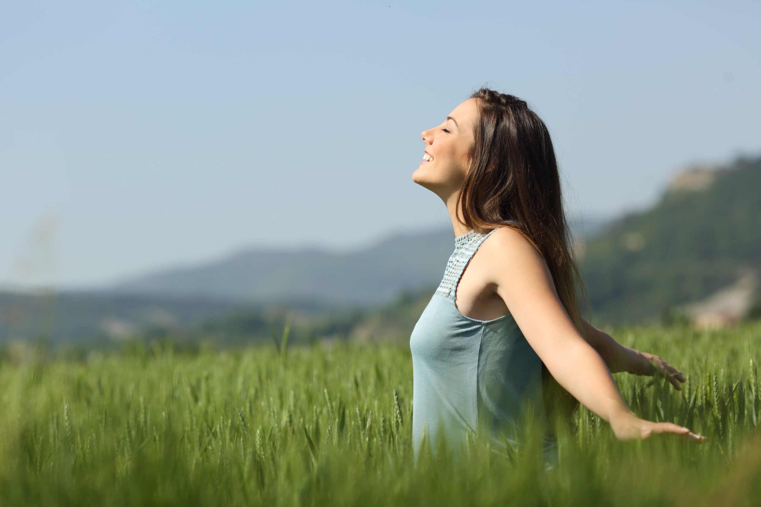 A person smiling or walking outdoors with a sense of peace