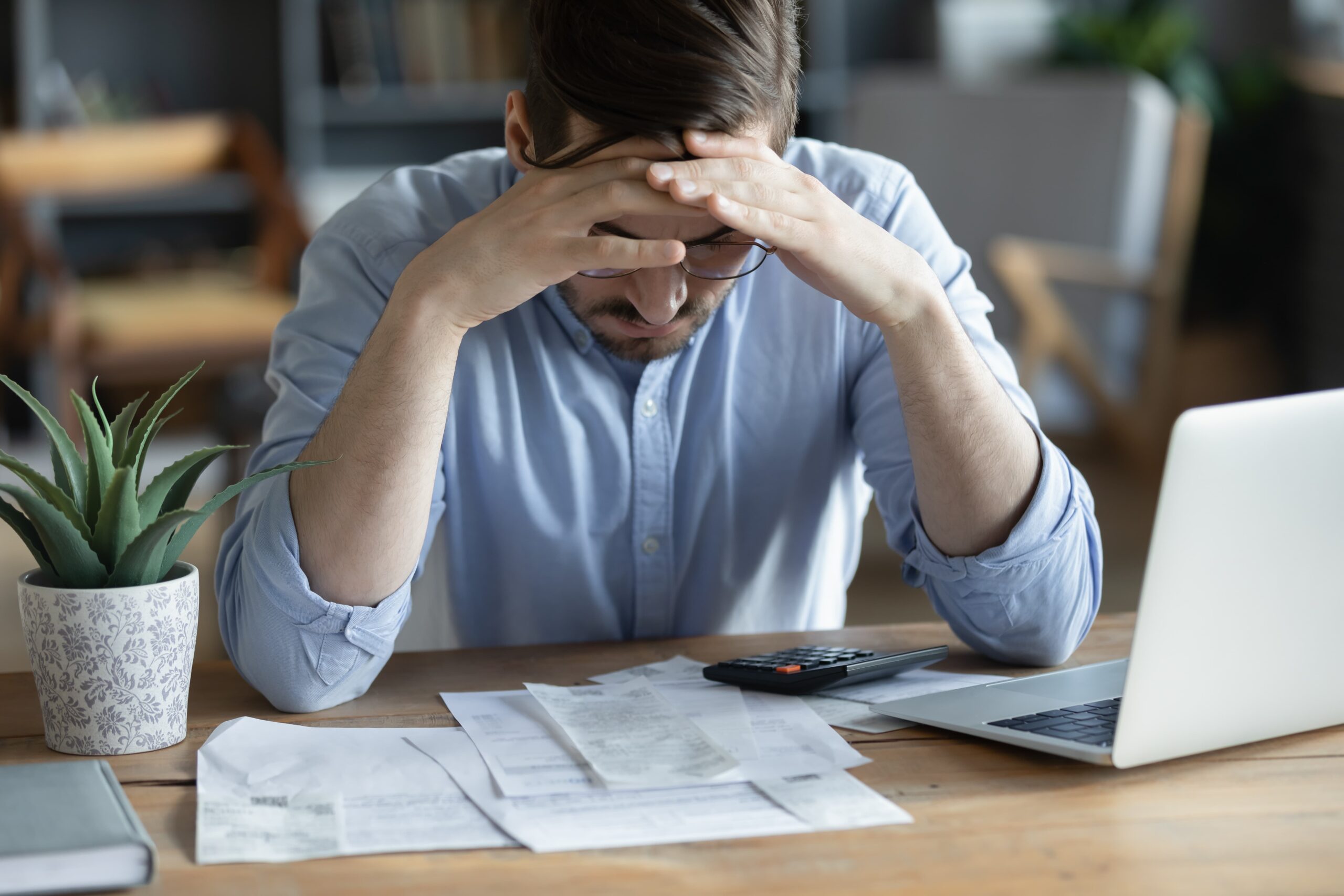 stressed individual facing alcohol-related financial difficulties
