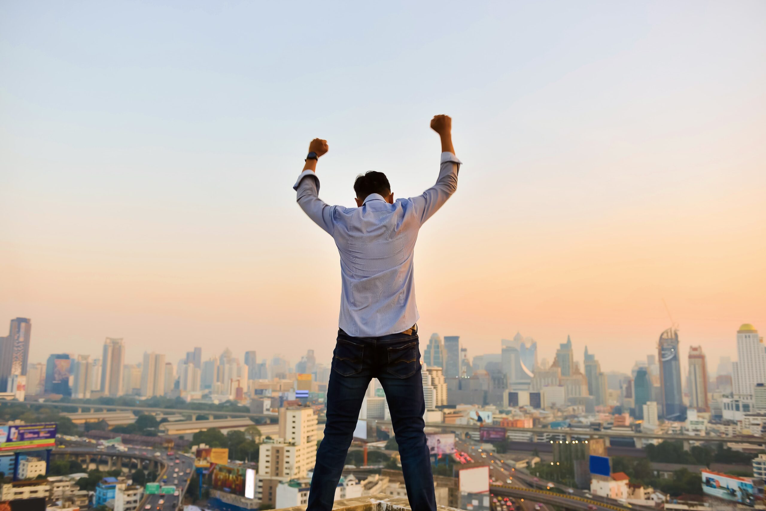 Successful businessman looking hands up