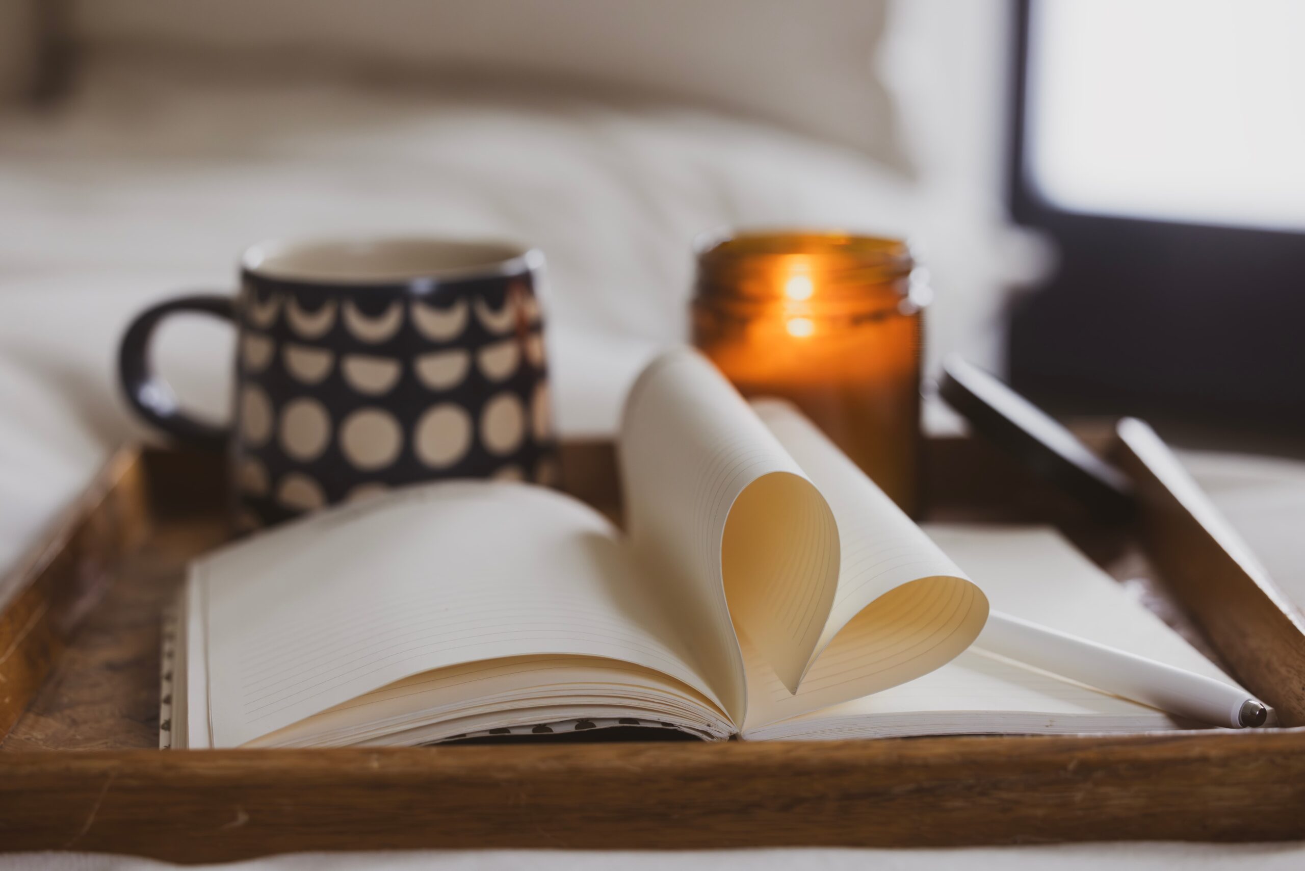 self-care setting with journal, candle, and blanket to support recovery during holidays