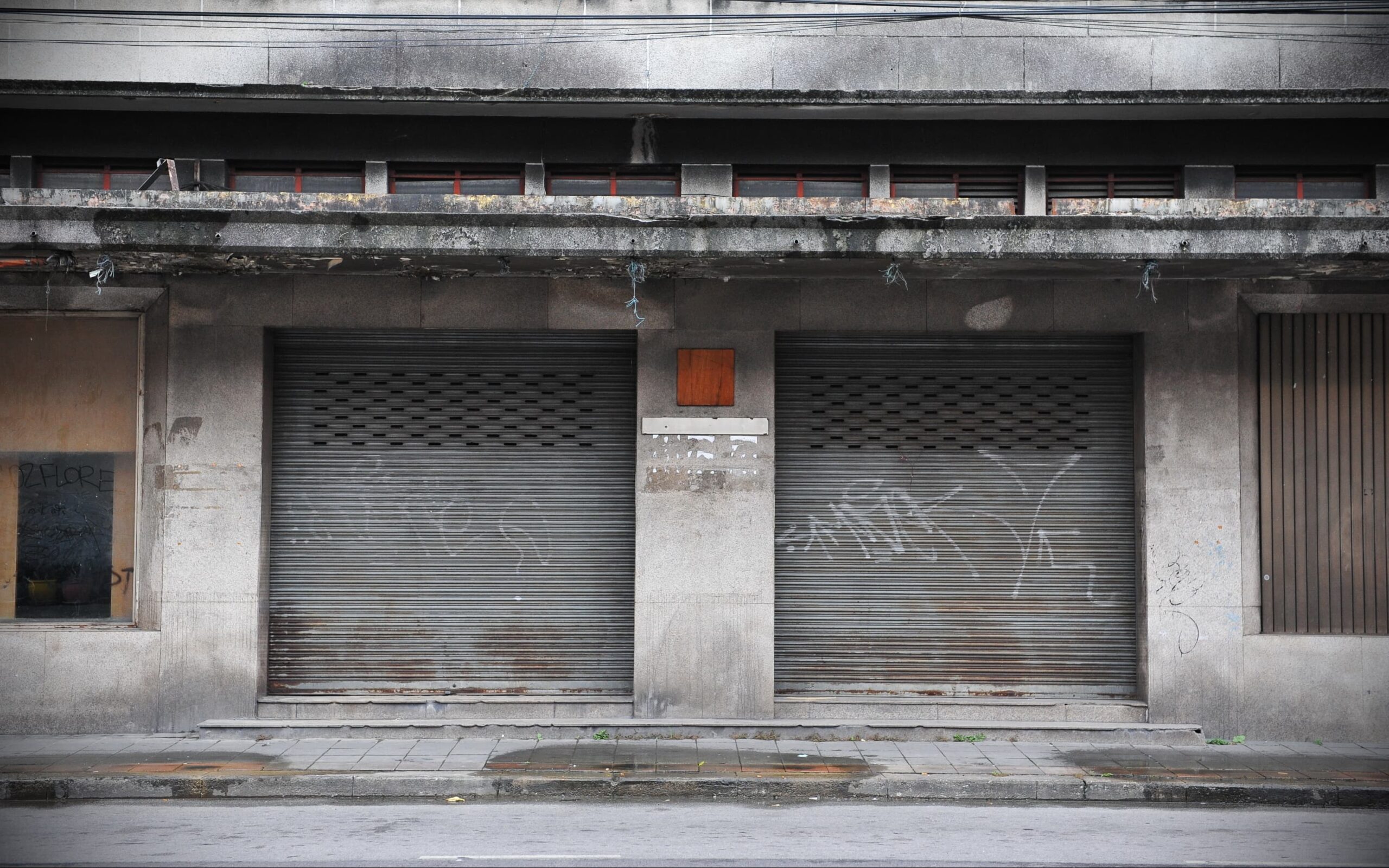 empty urban street with signs of neglect and limited resources