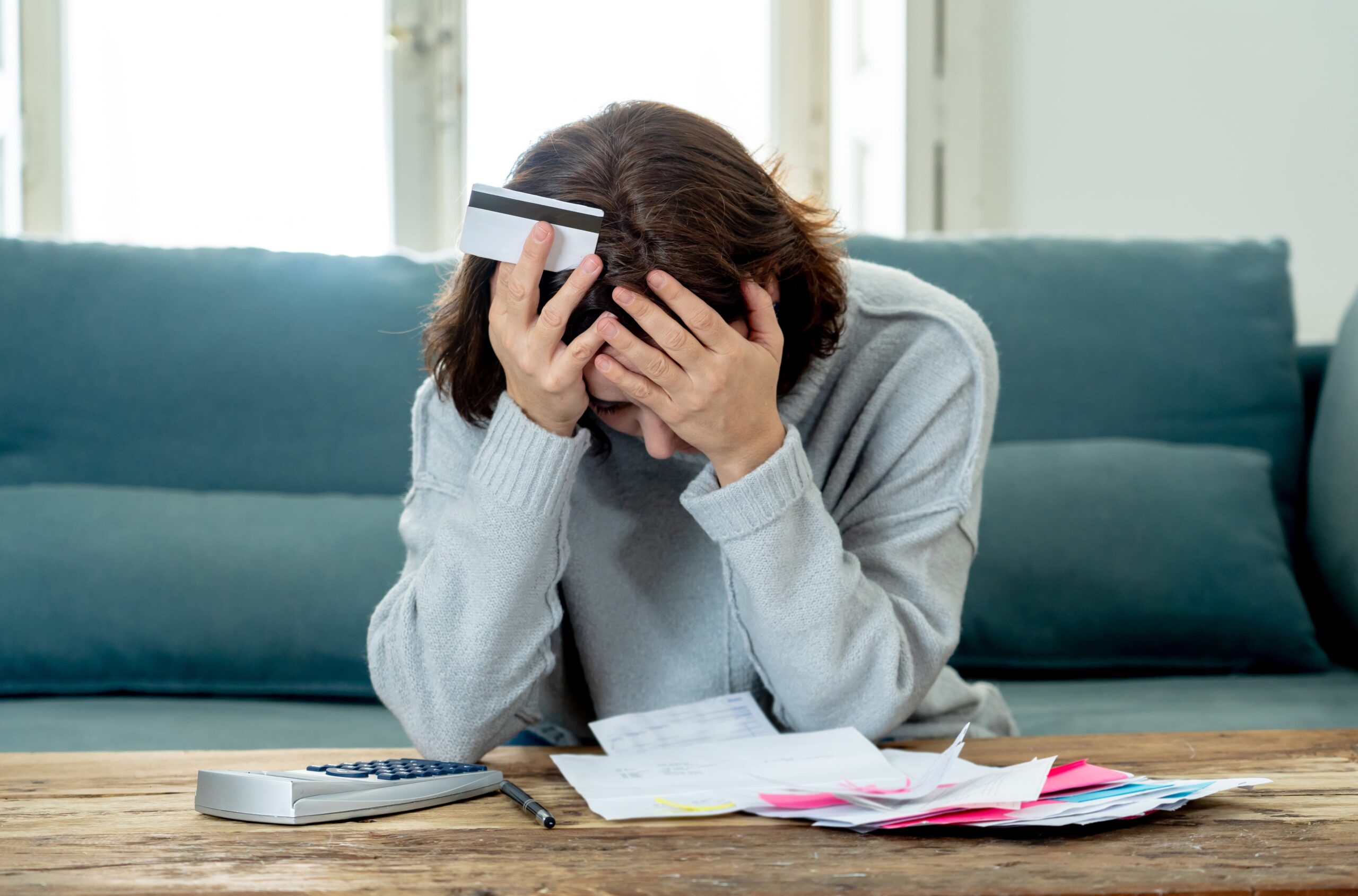 individual overwhelmed by addiction-related bills and stress