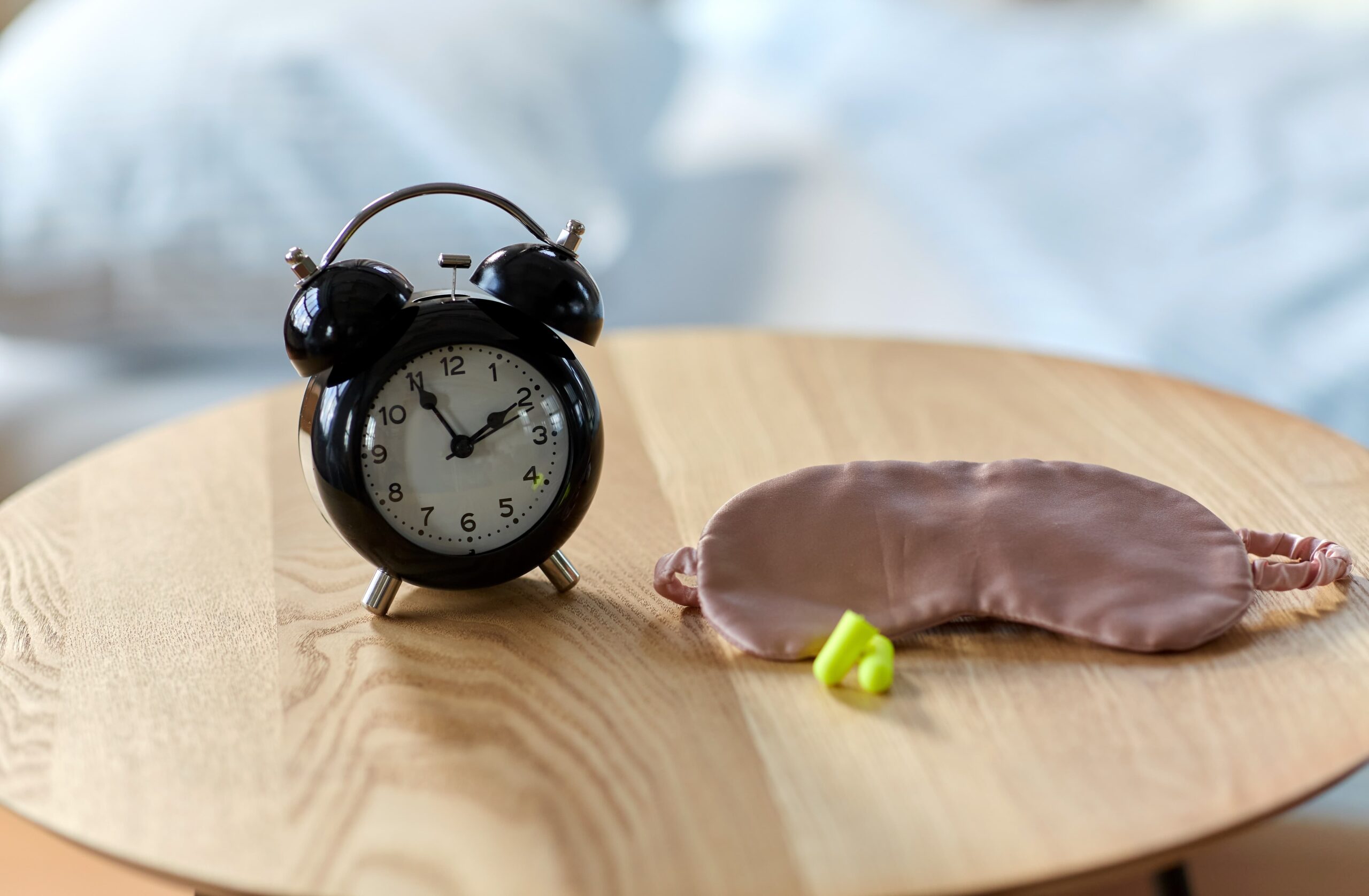 Nightstand with analog alarm clock and eye mask brain after long-term sobriety sleep routine