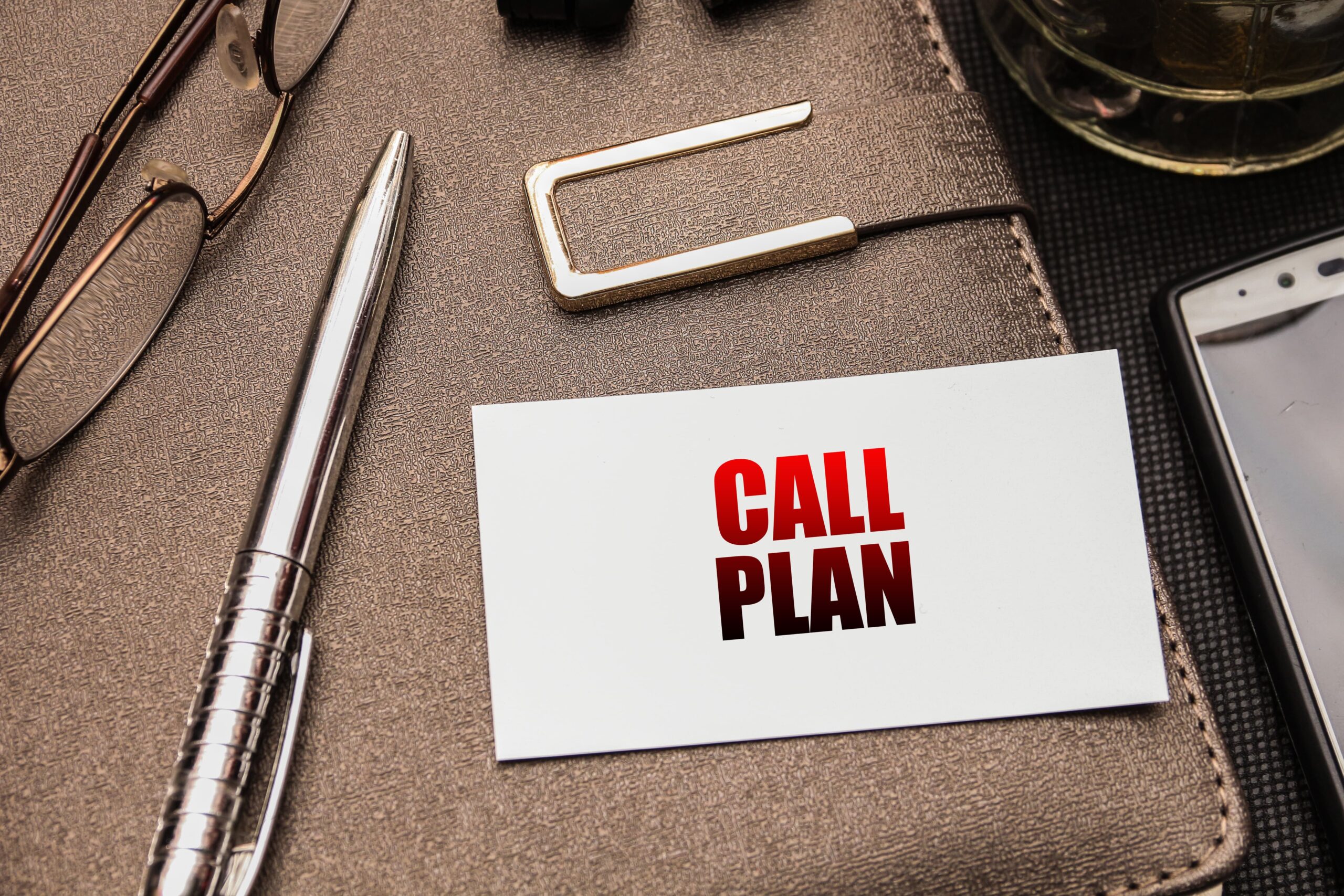 Wallet sized emergency plan card beside phone Wallet sized emergency plan card beside phone